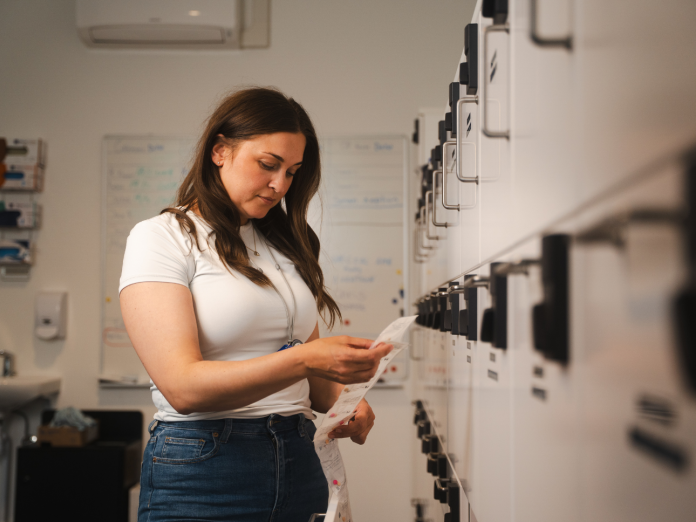 Medarbejder i gang med at sortere forskelligt medicin i forskellige medicinskabe